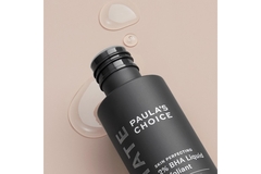 Image Paula's Choice BHA liquid on its side with some of it spilling out on a pink background.